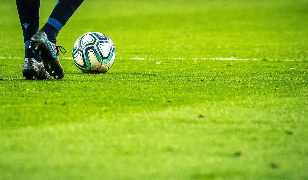 sport man playing soccer game on field ball